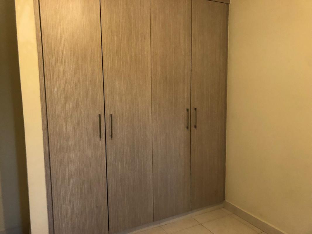 Spacious kitchen with granite countertops and ample wood cabinetry in PH Quintas de Versalles Panama