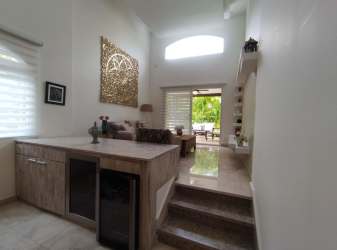 Double-height living room with marble floors and large windows in Eagle Model house at Tucán Country Club Panama