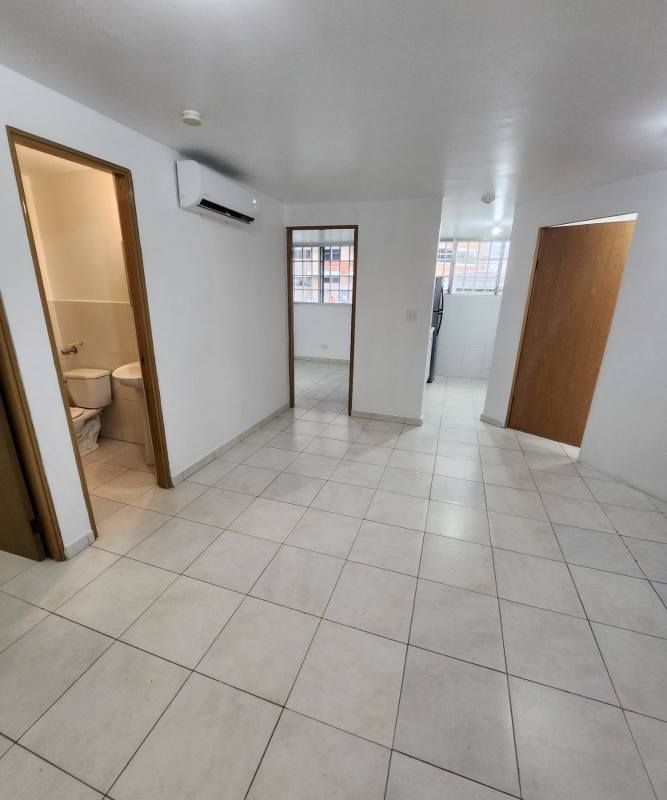 Bright tiled living room with AC unit in PH Llano Bonito Panama City apartment for sale