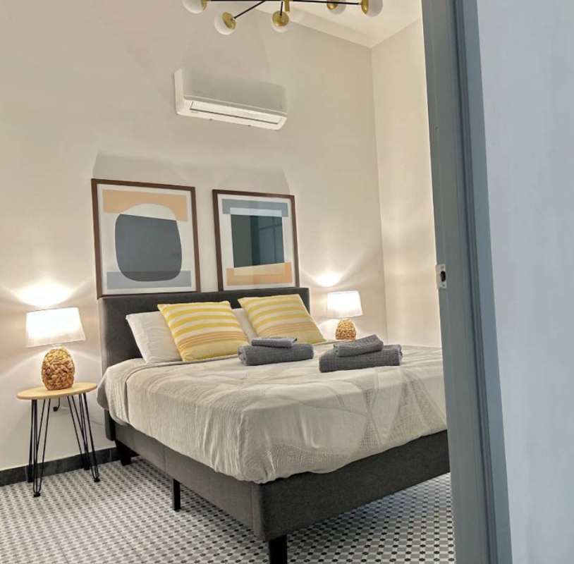 Modern bathroom with floating vanity, wood-framed mirror, white tiles Casco Viejo Panama