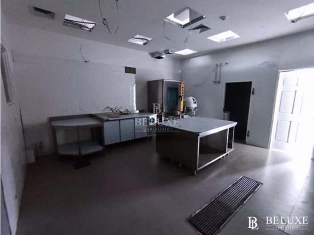 Colorful modern juice bar interior with pink and green graphics and glass counter Plaza 68 Panama San Francisco