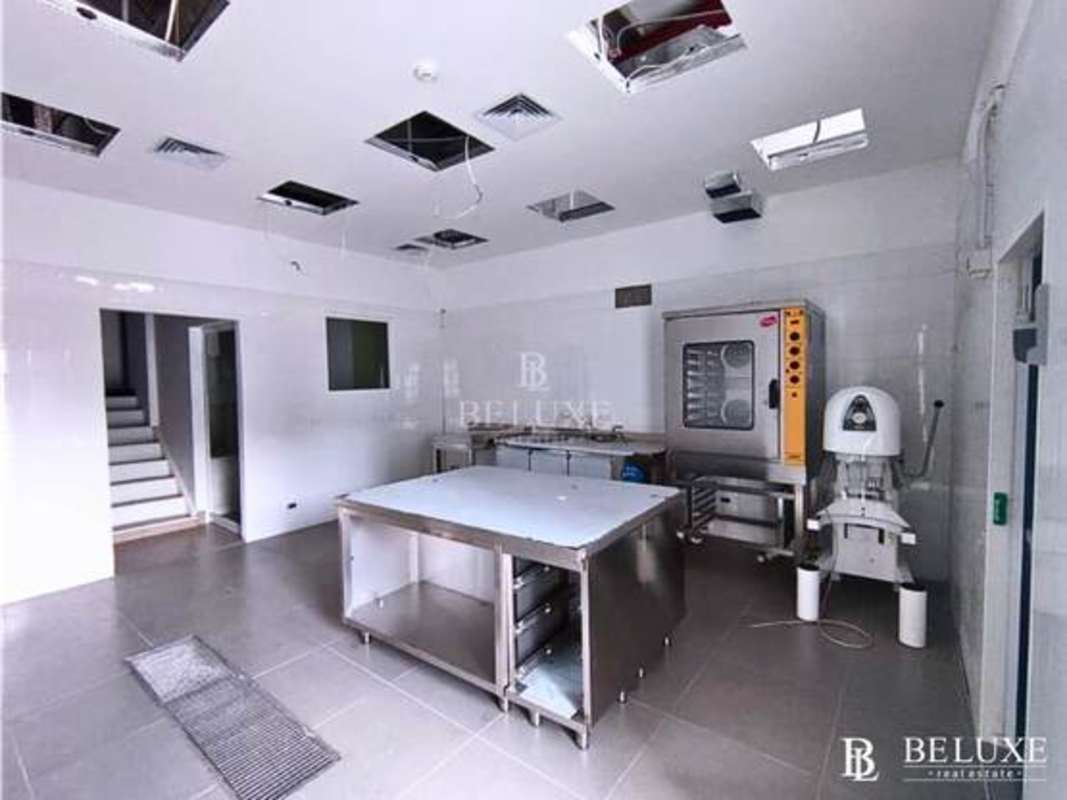 Industrial kitchen setup with stainless steel prep tables skylights and mixers Plaza 68 San Francisco Panama City