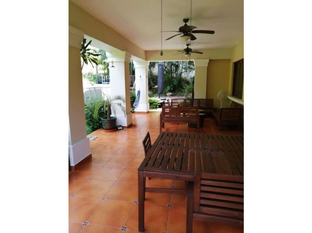 Bright living room with large windows, chandelier, ceramic floors in luxury house Clayton Panama