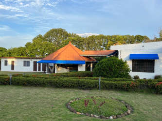 Mediterranean-style gated entrance with pergola, landscaped garden at country house in Las Lajas near Coronado