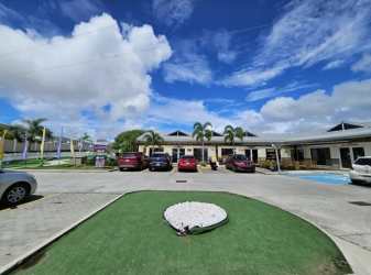 Single story house exterior beige with palm landscaping in Playa Dorada Panama