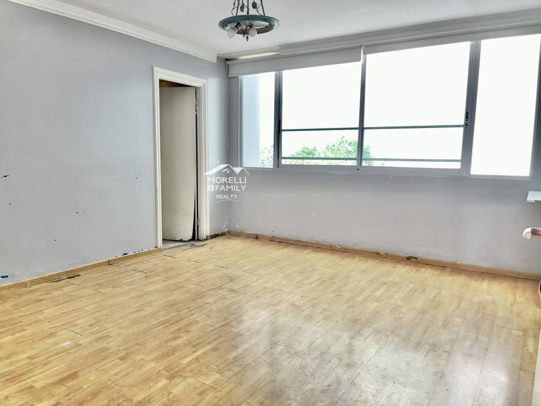 Kitchen area with wood cabinetry and granite countertops PH Pacific Wind Punta Paitilla