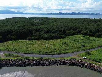 Waterfront lot aerial with mountain backdrop in La Claridad Nueva Gorgona Punta Chame Panama