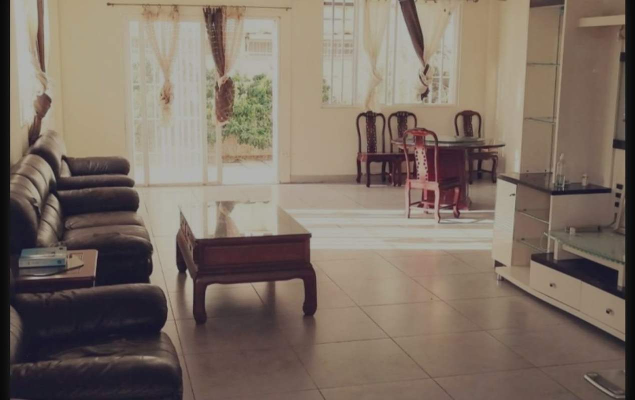 Large living dining area with sofa, coffee table, entertainment unit, sliding glass door in PH Brisas Point