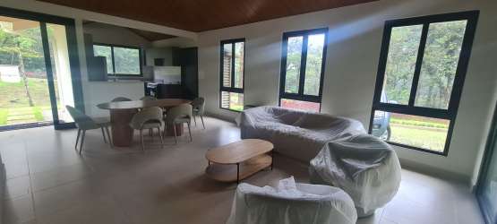 Living-dining open floor plan with large windows facing greenery PH Valle Bonito Panama
