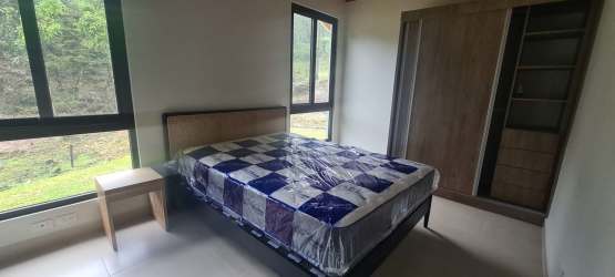 Bedroom with large windows, wood ceiling, modern finishes overlooking nature at PH Valle Bonito Panama
