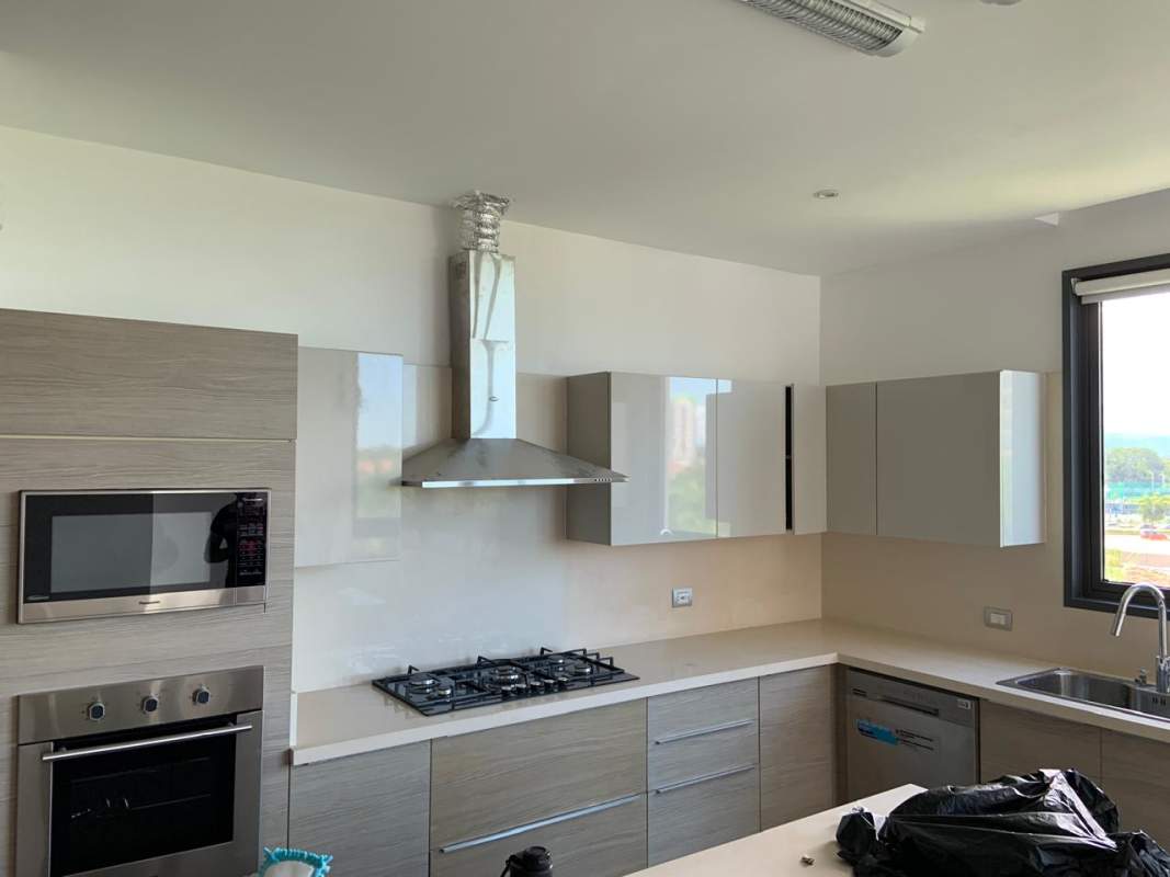 Modern living room with marble floors, large windows, panoramic city skyline views in PH Vittoria Panama