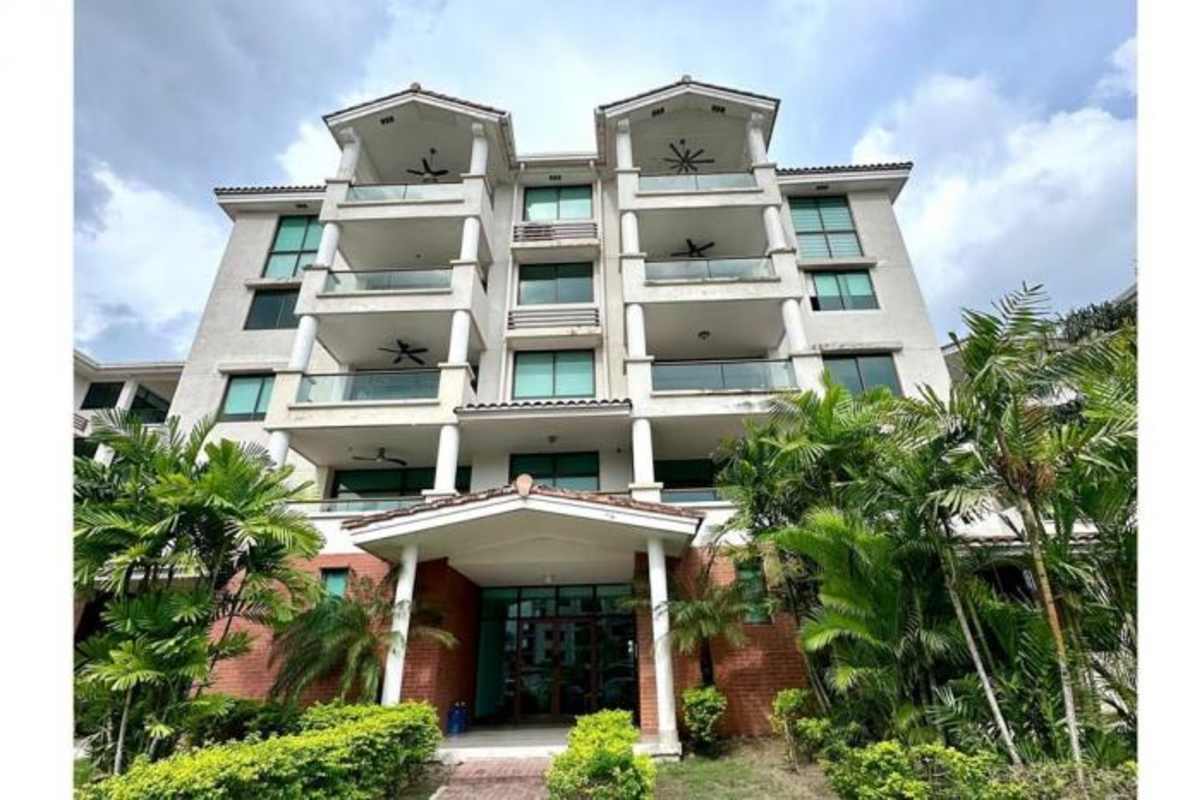 Four-story Mediterranean-style condo building with balconies and landscaping in Costa Sur Panama