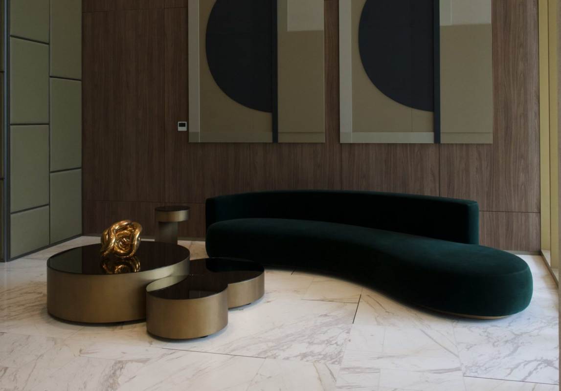 Elegant contemporary lobby with velvet curved sofa, gold accents in PH La Maison by Fendi Panama