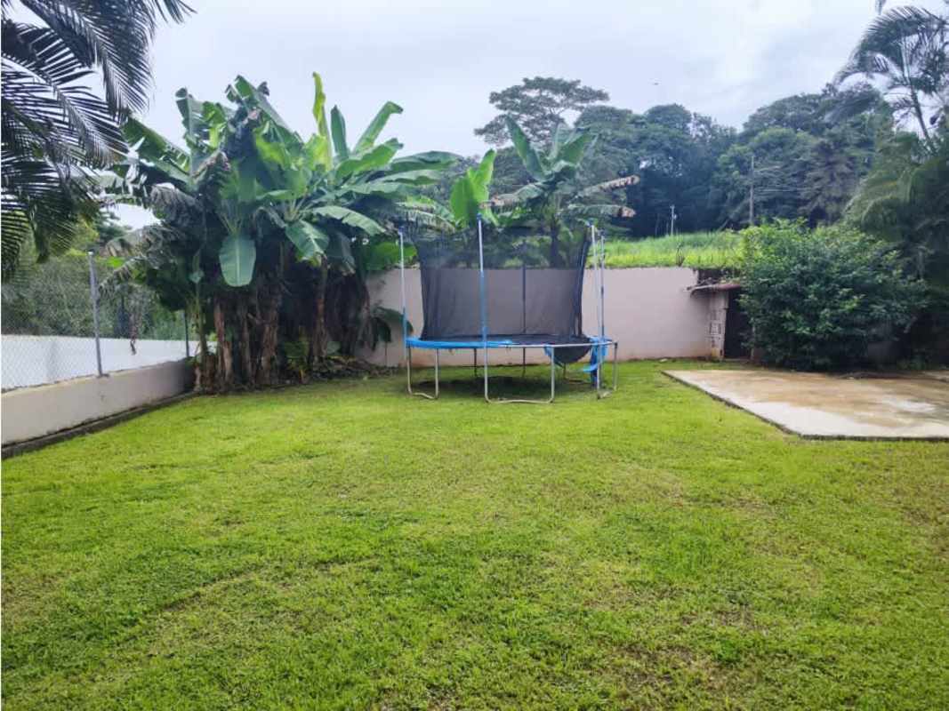 Fenced backyard tropical plants trampoline family house Villa Zaita Panama City