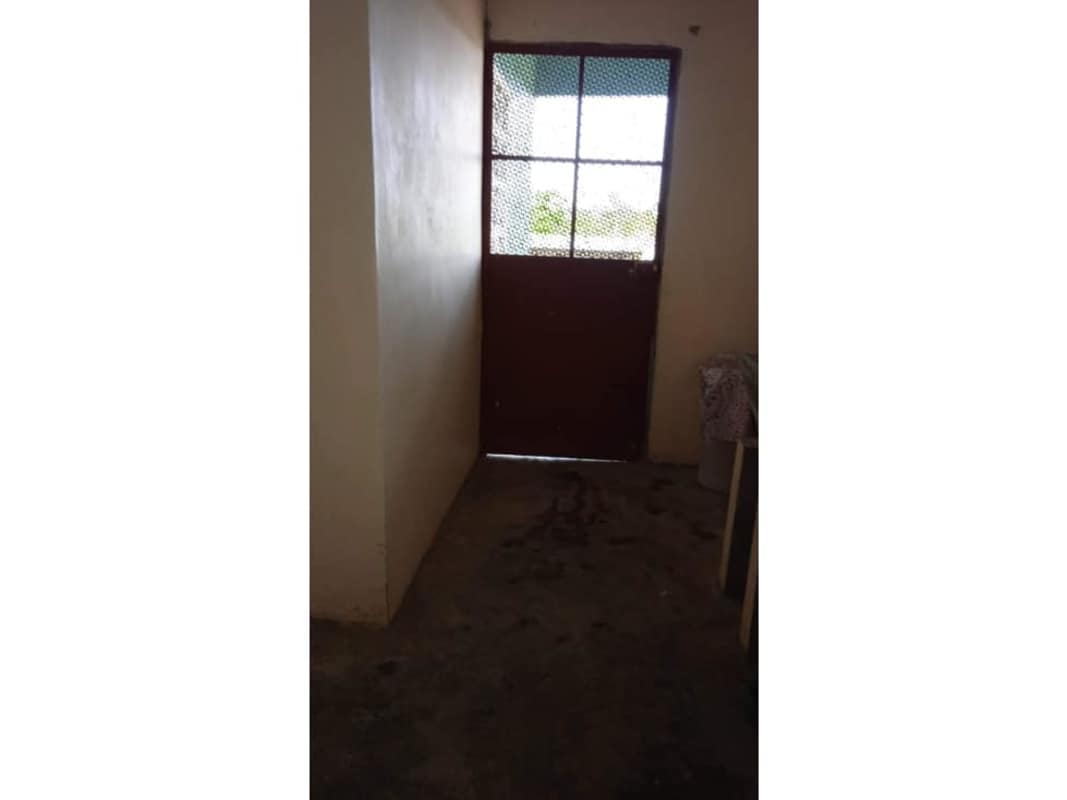 Entrance hall with metal door, concrete unfinished floor near porch Chepo Panama real estate