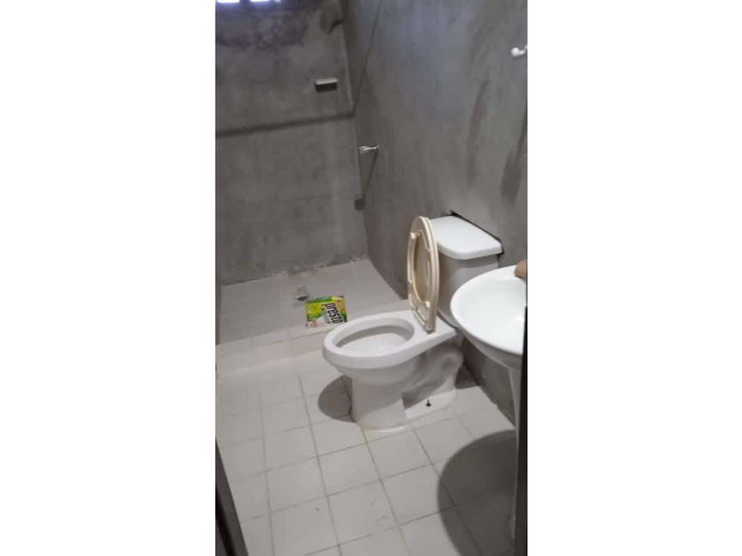 Interior hallway space with concrete floor and doors inside Chepo Panama house for sale