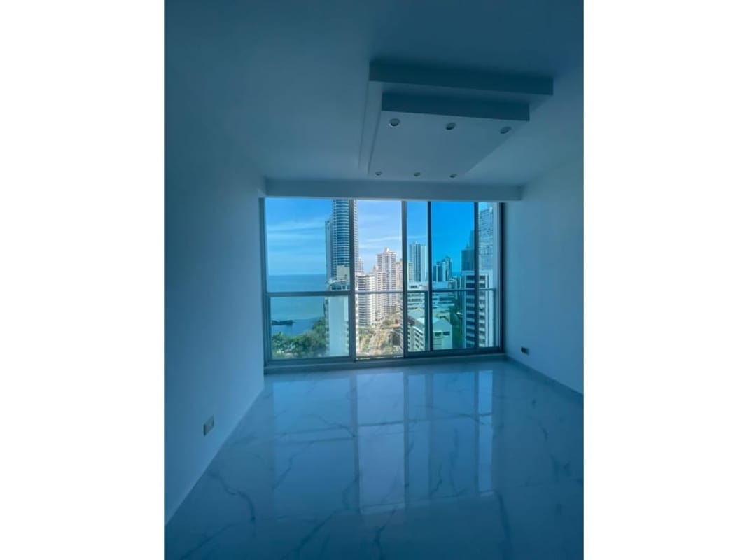 Modern living room marble tile AC large windows ocean skyline PH Pacific Sky