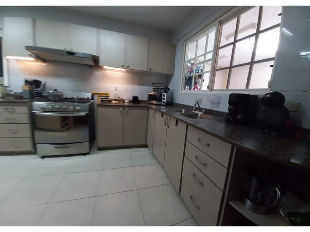 Kitchen with granite countertops, beige cabinetry, stainless steel fridge Villa Alta Panama