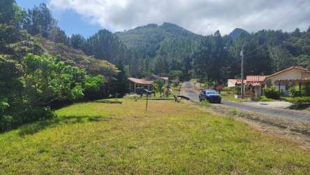 Mountain countryside grassy lot with paved road in Altos del María Panama