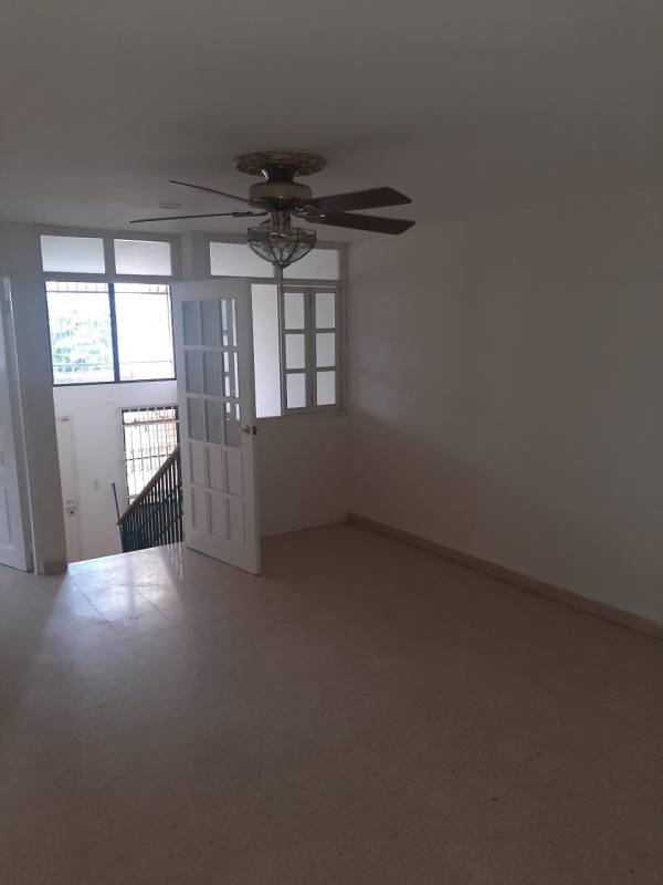 Living room area with windows, bars, ceiling fan and neutral decor Betania Panama