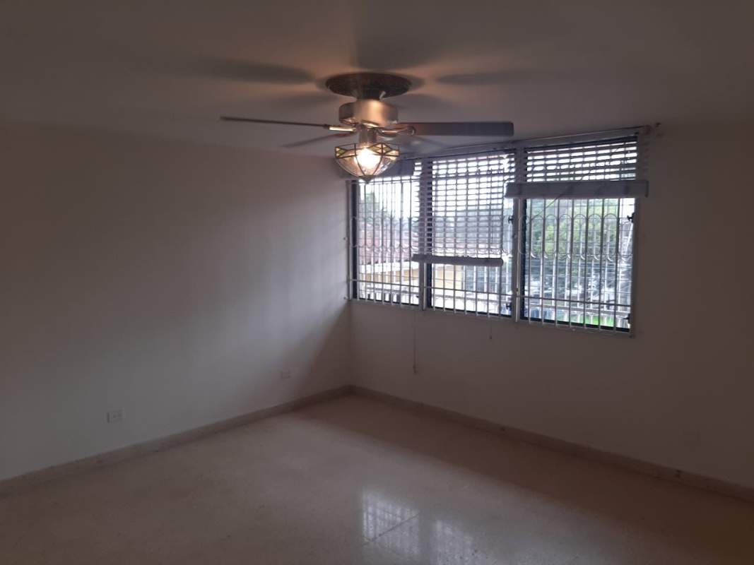 Living area with windows and French doors inside duplex house in Panama City