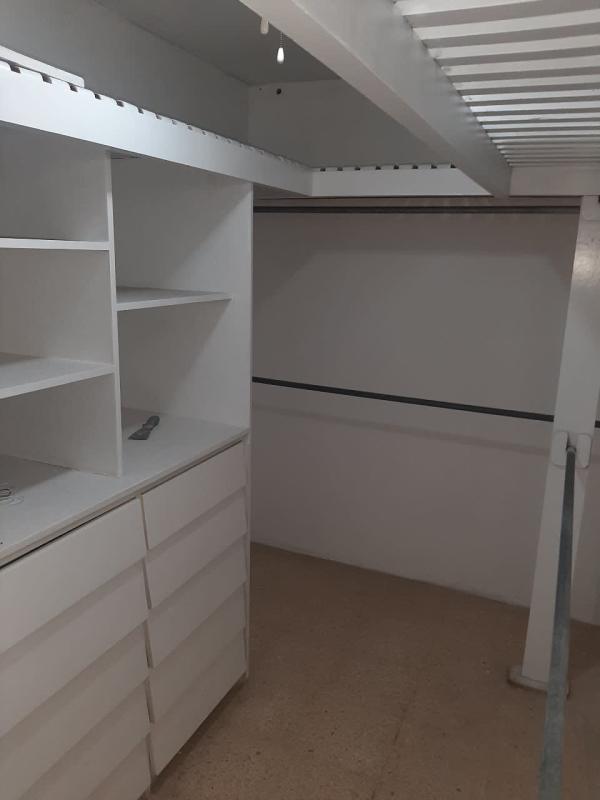 Large walk-in closet with drawers and shelves in Betania duplex house Panama