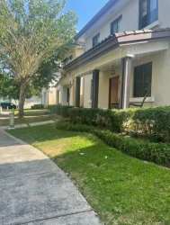 Two-story cream townhouse with porch and garden in River Valley Panama Pacifico