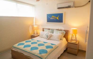 Resort-style swimming pool surrounded by palm trees at PH Las Islas Punta Barco Panama