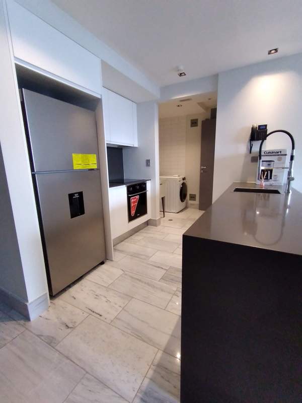 Spacious modern living room with large windows and ocean view balcony in PH BICSA Financial Center Panama City