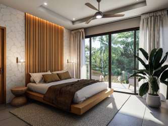 Bright open concept living room and kitchen with tall ceilings and garden views in eco villa Pedasí Panama