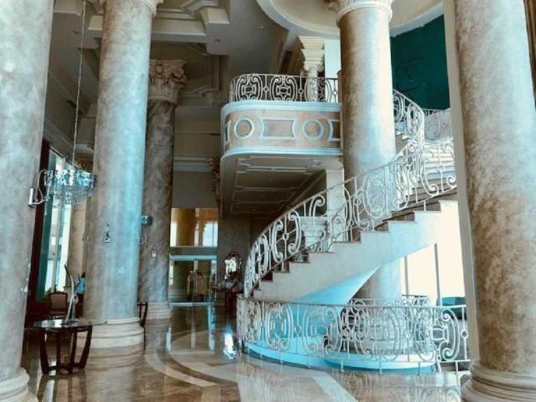 Luxurious neoclassical lobby with marble floors and spiral staircase in PH Venetian Tower Panama