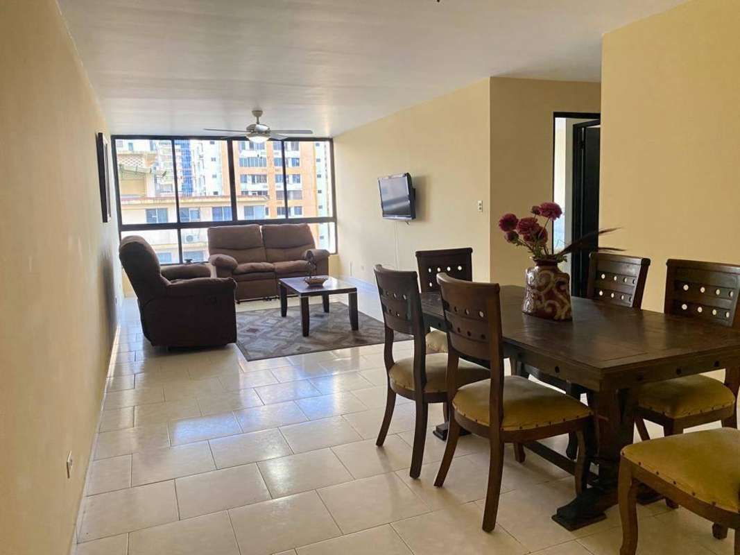 Cozy living room with window view, TV, and fan, El Cangrejo Plaza Panama
