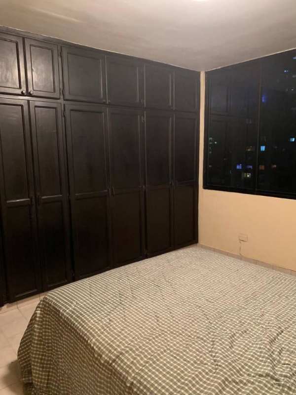 Bedroom with large wardrobes, AC unit, and night city view in El Cangrejo Panama
