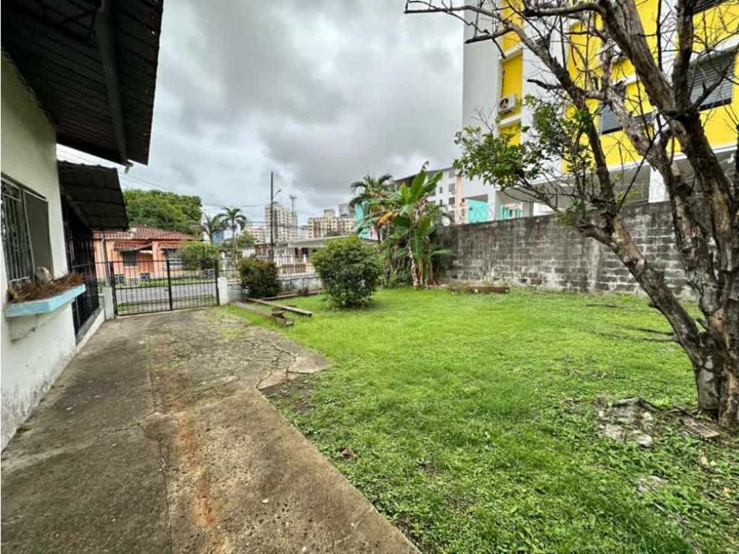 Front yard with concrete walkway, green lawn, mature tree Parque Lefevre Panama