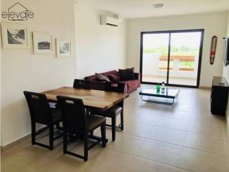 Living room with sliding glass doors to ocean view balcony in Playa Caracol condo Punta Chame Panama