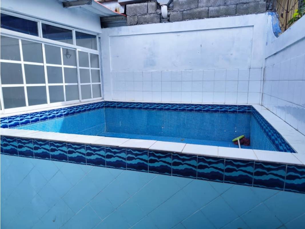 Contemporary kitchen featuring granite countertops, wood cabinetry, tiled walls Rufina Alfaro Panama