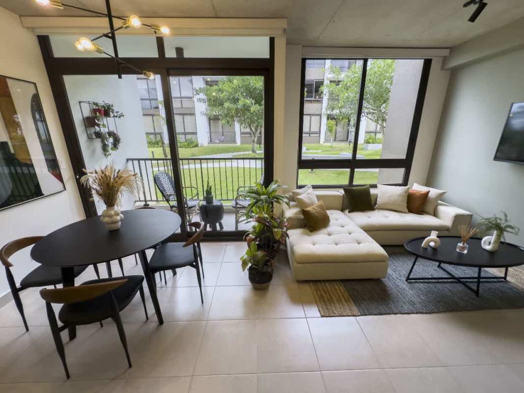 Living space with balcony overlooking gardens PH Begin CoLiving Brisas del Golf Panama