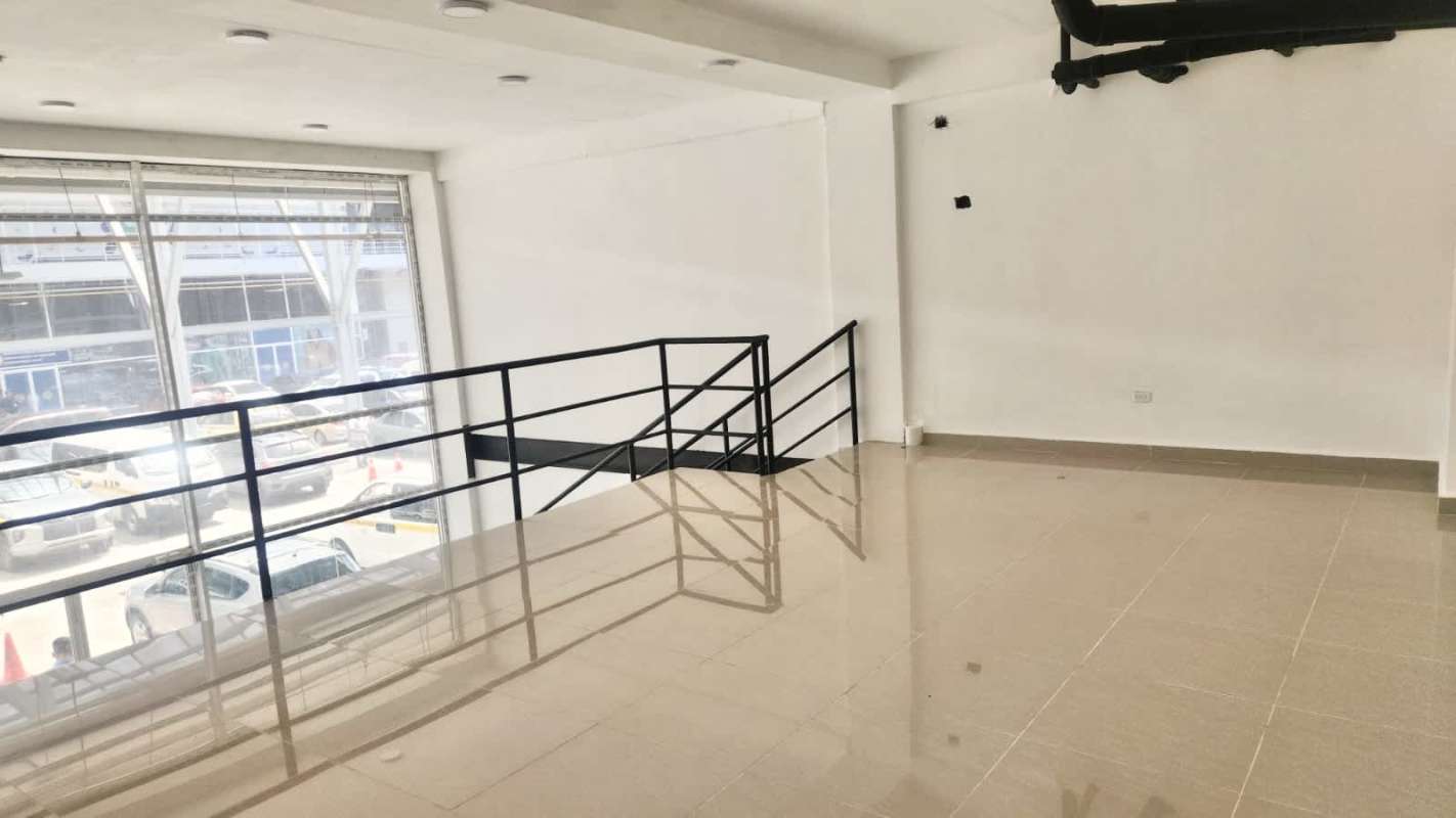 Glass facade shopping plaza and parking area at Galerías Panamericana Panama