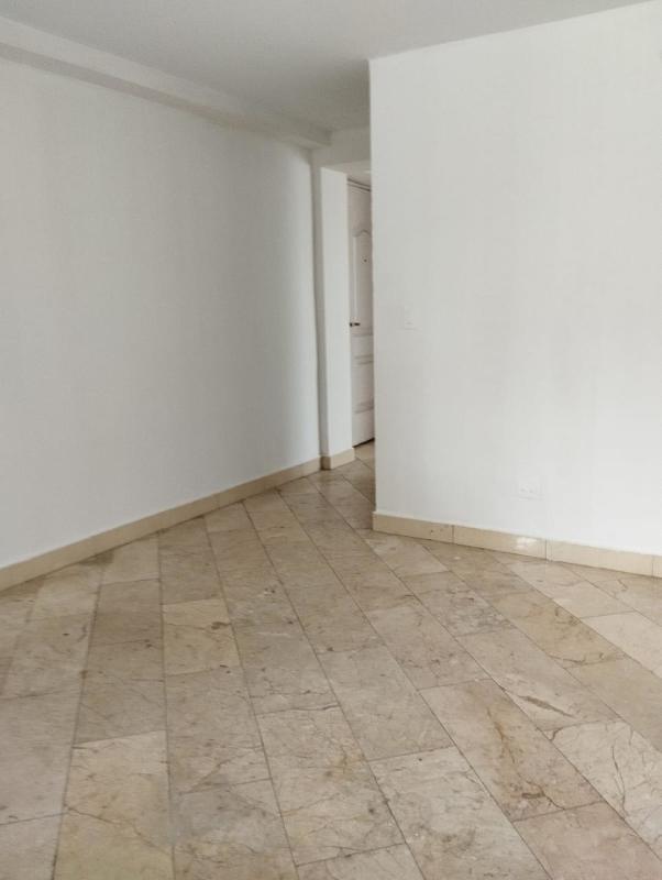 Interior hallway with marble tiles and white walls in studio at PH Dos Mares Panama