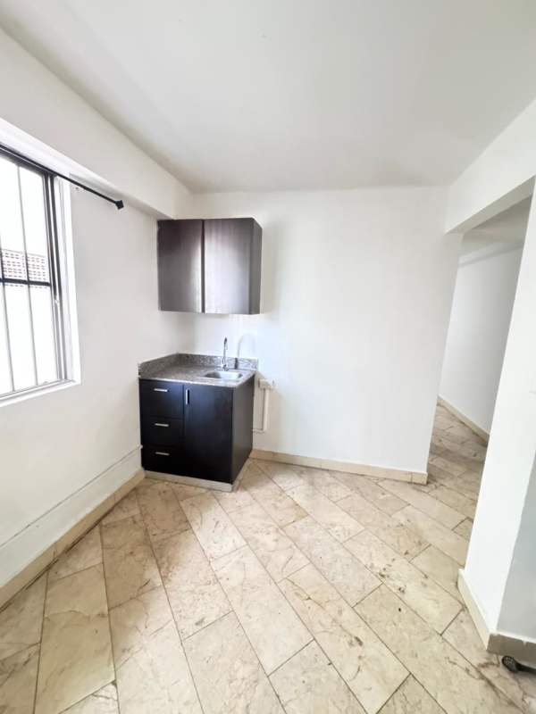 Small kitchenette with granite countertop and cabinets in PH Dos Mares Panama City