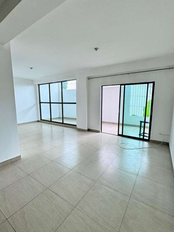 Covered balcony with view of cityscape and greenery in apartment PH Dos Mares Panama