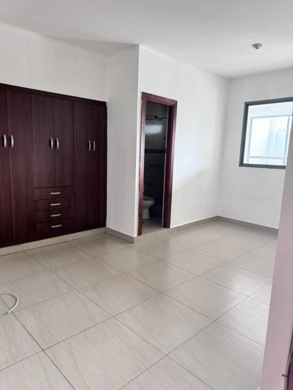 Bedroom with closet and window to city in apartment Dos Mares Panama City for rent