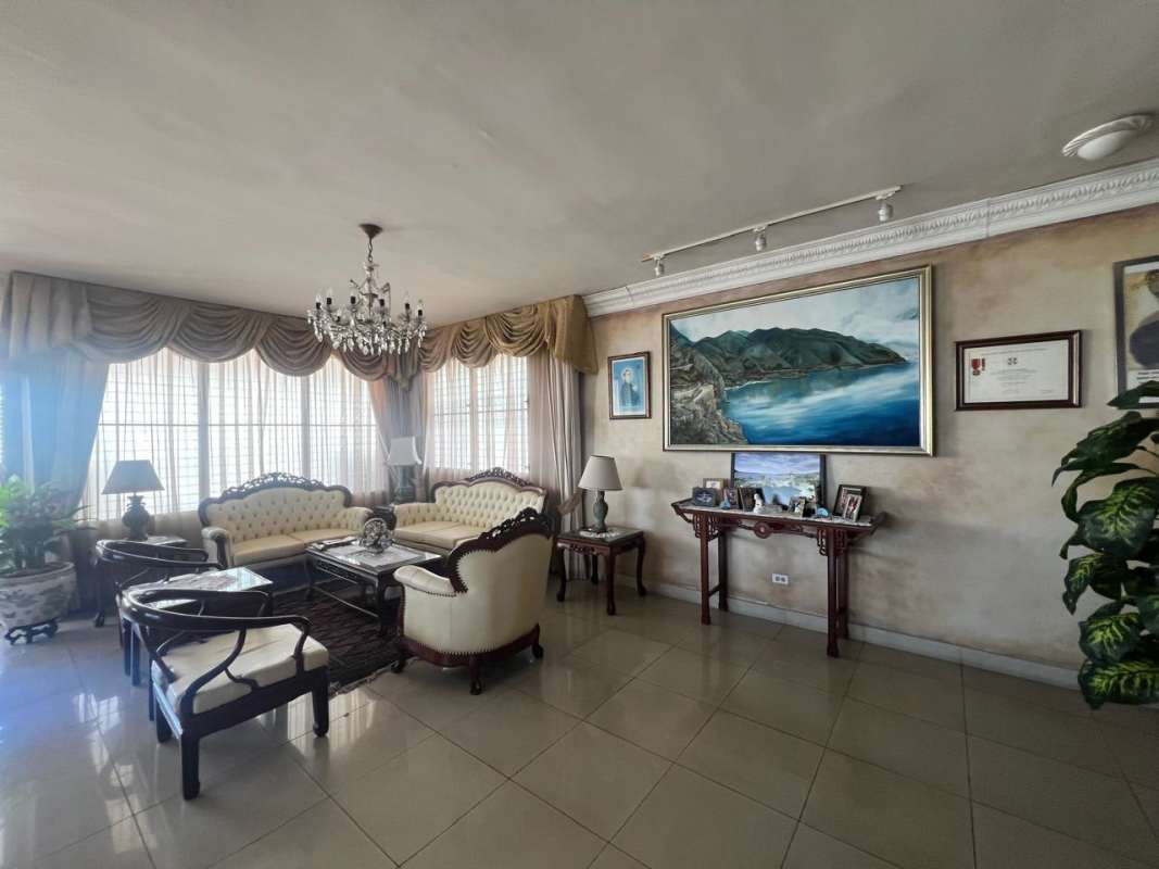 Master bedroom with large window, wood bed, floral mural accent wall in PH Acquafredda Panama City