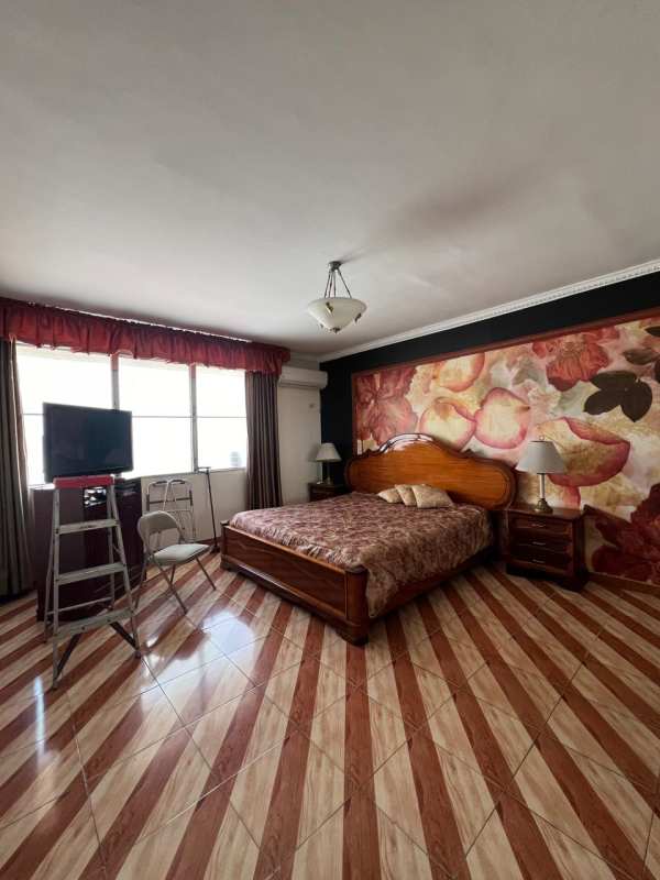 Traditional dining room with chandelier near large window in PH Acquafredda Panama City