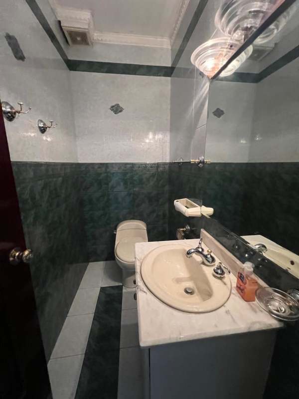 Bathroom with tiled walls, single sink vanity and mirror in PH Acquafredda Panama City