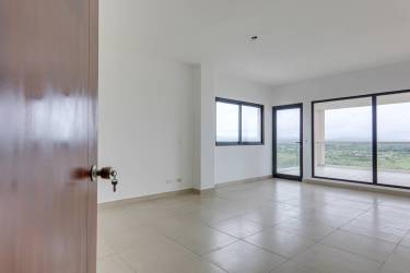 Spacious living room with floor-to-ceiling windows showing Pacific Ocean at Vista Mar Resort Penthouse