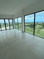 Oceanfront infinity pools with sun loungers and beach club at Vista Mar Golf & Beach Resort Panama