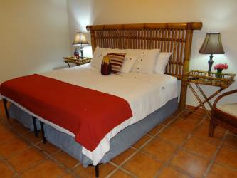Bedroom with bamboo headboard and tropical decor at Buenaventura luxury villa Panama