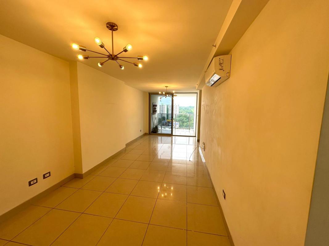 Spacious living room with sliding doors to balcony city view in PH Rokas Condado del Rey Panama
