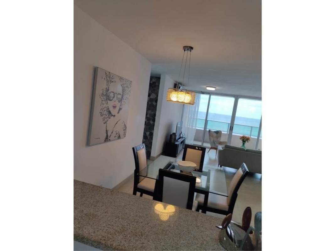 Living room with glass sliding doors opening to balcony with oceanfront view in PH Terras San Francisco